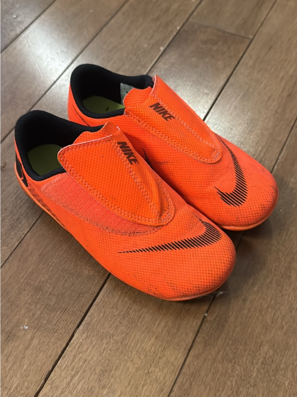 Nike Kids Orange Slip-On Soccer Sneakers with Black Swoosh
